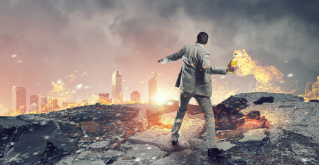 Businessman throwing petrol bomb . Mixed media