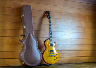 Electric Guitar and case in wood room