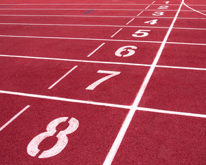 Red running track on the athletic stadium.
