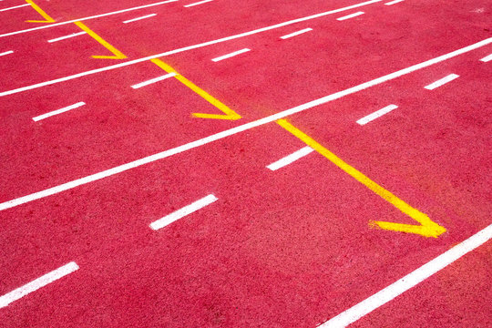 Red running track on the athletic stadium.
