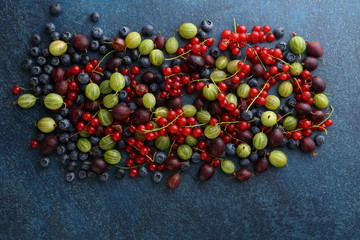 Summer organic berries on stone background.