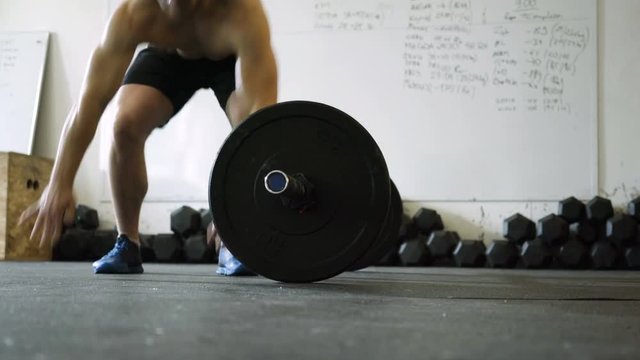 Closeup of young man doing burpee over the bar exercise