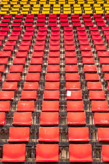 Naklejka premium empty seats red plastic in a stadium. 
