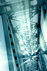 Naklejka premium Railway metal bridge perspective view. Ray lights glowing. Monochrome image