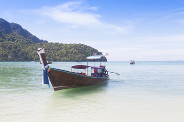 Traditional thai longtail boat on emerald sea at  Andaman sea