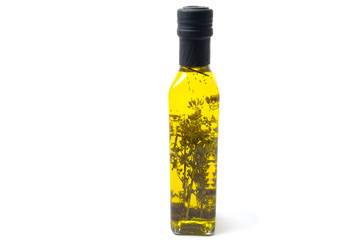 Bottles of extra virgin olive oil with oregano isolated on white