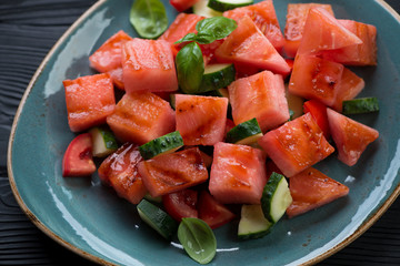 Grilled watermelon, tomato and cucumber salad, close-up