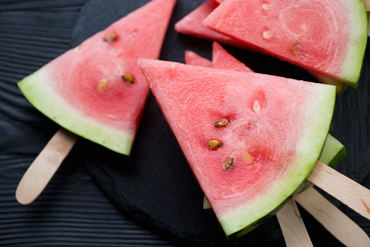 Summer refreshment with watermelon on sticks, close-up