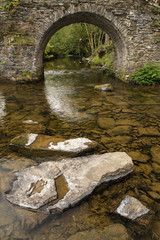 Fototapeta na wymiar Landscape image of medieval bridge in river setting in English c