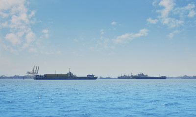 Cargo ship with shipping port over blue sea