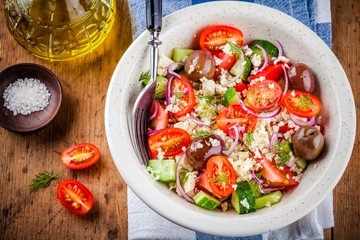 salad with tomatoes, cucumbers, olives, onions, feta and couscous