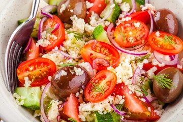 salad with tomatoes, cucumbers, olives, onions, feta and couscous