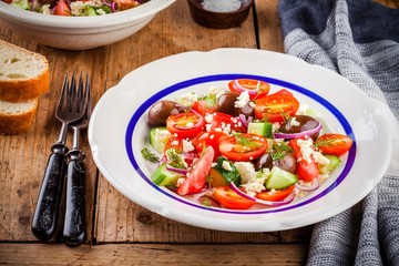salad with tomatoes, cucumbers, olives, onions, feta and couscous
