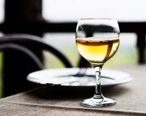 Wine glass and cutlery on the table.