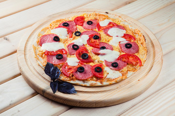 Italian pizza on the wooden background