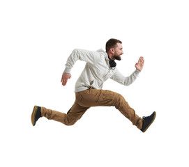 Young bearded man in mid-air jump over white background