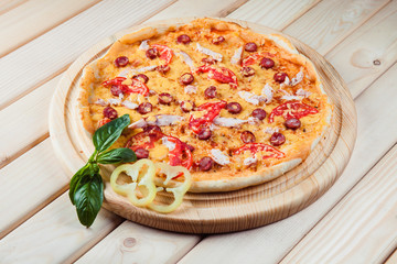 Meat Pizza with tomatoes on the wooden background
