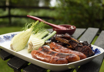 Plate with grilled sausages and ribs and fennel, picture from Sweden. 
