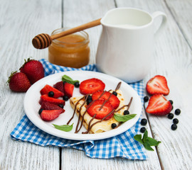 crepes with strawberries and chocolate sauce