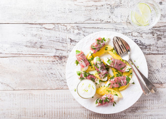 Rolls of mozzarella, basil and Parma ham