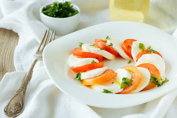Dish with caprese salad with mozzarella