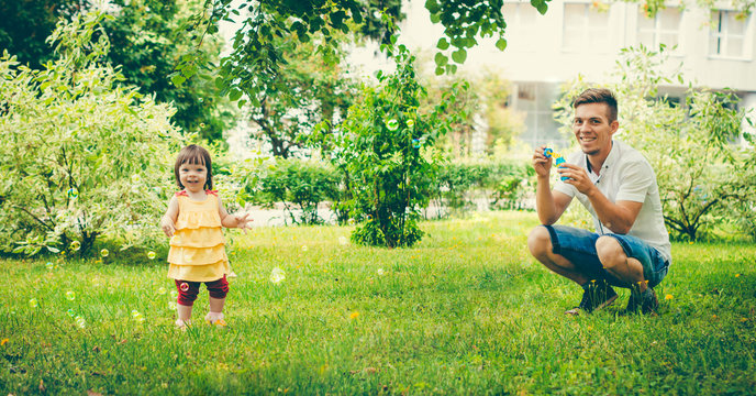 Dad and his daughter are making bubbles