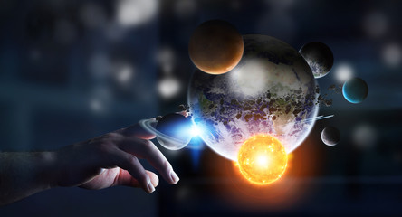 Businessman touching solar system with his fingers