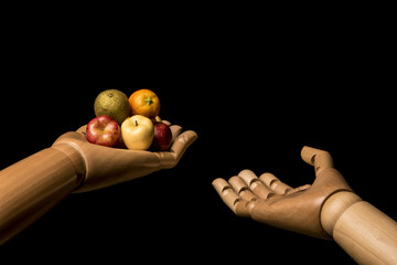 An empty hand claims the charity a hand holding fruits. Isolated on black background. With copy...