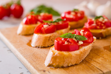 Fototapeta na wymiar Closeup of Italian bruschetta with tomato, basil and garlic