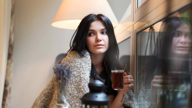 Portrait of a young caucasian teen girl with a cup of tea. HD cinemagraph - motion photo seamless loop