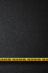 Yellow police line in the background smooth asphalt road. Do not cross. The texture of the tarmac, top view.