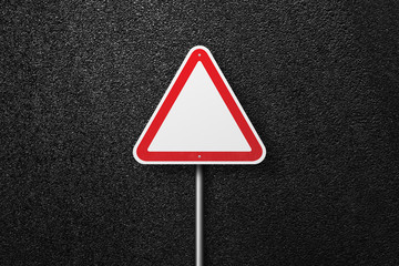 Road signs of the triangular shape on a background of asphalt. The texture of the tarmac, top view.