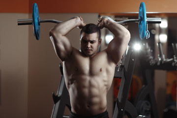 Fototapeta na wymiar Fitness man exercising with barbell in gym