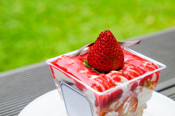 Strawberry crumble dessert cookie and cream sweet on table in garden backyard
