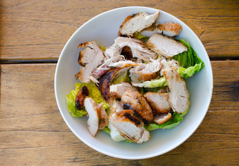Chicken salad in a bowl on a wooden table from above