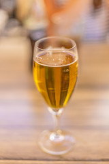 Blond beer on a glass isolated on a wooden table