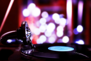 Fototapeta na wymiar Turntable with vinyl record on dark blurred background