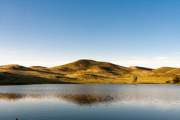 Lake amongst the trees and hills in the summer.