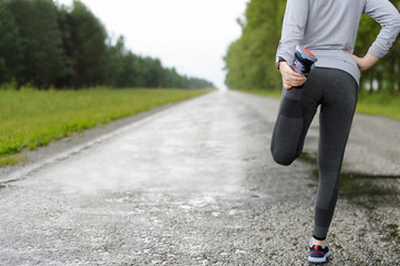 Running stretching in the rain.