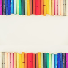 Colorful pastel oil crayon lines up, on white background with copy space