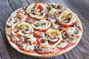 Whole pizza on wooden board