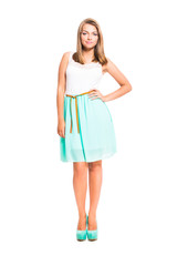 Cute young girl in summer clothes isolated on white background.