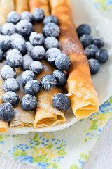 pancakes with blueberries on wooden surface