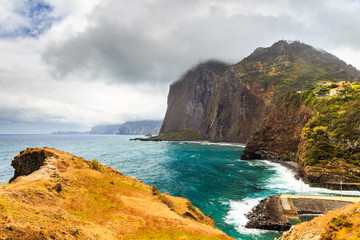 Rocky beach and cliffs on the northern coast of Guindaste, Faial, Madeira, Portugal.