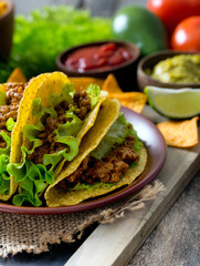 plate of tacos, nachos and tomato dip