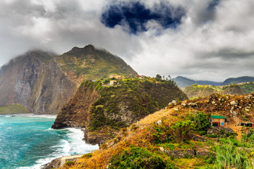 Fototapeta premium Rocky beach and cliffs on the northern coast of Guindaste, Faial, Madeira, Portugal.
