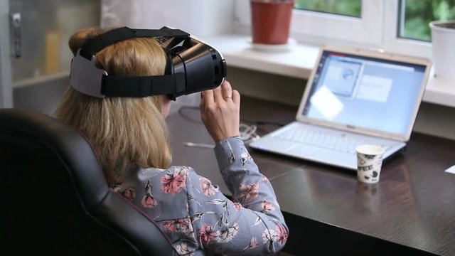 A woman working in a virtual reality 3D headset