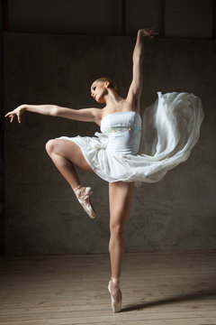 Fototapeta Beautiful ballerina dancing in white dress