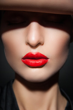 Close-up of model with red lips and perfect skin