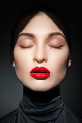 Attractive young model with red lips and forehead in shadow